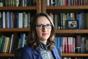 Eva Gurevich in front of bookshelves